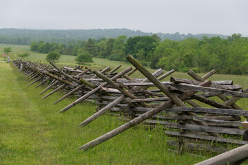 Fototapeta na wymiar Stacked wooden fence on the edge of the Gettysburg battlefield, site of the bloodiest battle of the Civil War