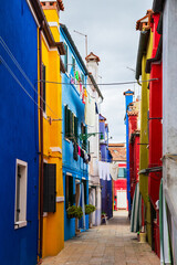 Bright traditional colorful buildings on Burano island, Venice, Italy. Picturesque narrow old...