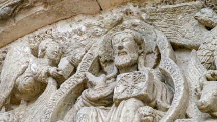 Stone image of an episode from religion on the wall of the church