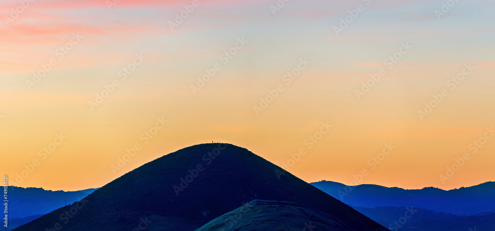 Wall mural silhouette of hill at sunrise, sunset