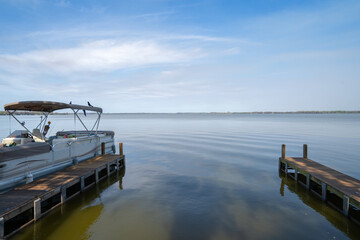 Fototapeta na wymiar Pontoon boat docked on a lake in Florida