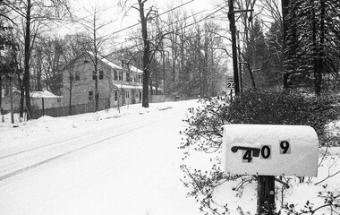 suburban street covered with snow after the storm in black and white