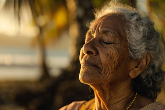 Photo of a senior practicing meditation in a tranquil setting with a close up on their serene face and the peaceful backdrop illustrating mental health care