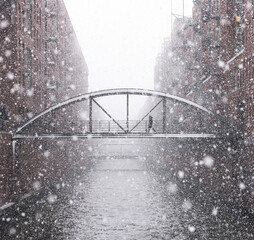 Hamburg warehouse district bridge over river in winter snow