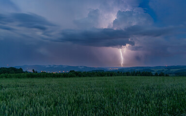 Fototapeta na wymiar Lightning flash against the background of mountains