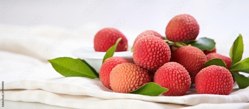 Sticker A cluster of ripe strawberries resting on top of a pristine white cloth. The vibrant red berries contrast beautifully with the clean background, creating a visually appealing composition.