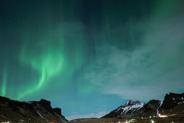 Northern Lights and Clouds in Iceland in the Winter Night Sky in Vik