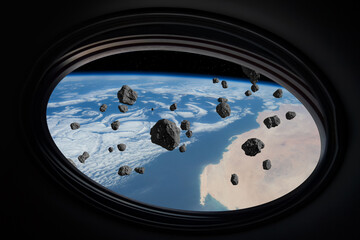 Earth and asteroids. Asteroids fly over the Earth, as seen from the window of a spaceship. ...