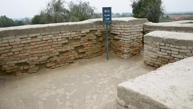 an expansive archaeological site featuring the ruins of an ancient civilization. The remnants of brick structures stand testament to the complex architecture and urban planning of Mohenjo Daro.   
