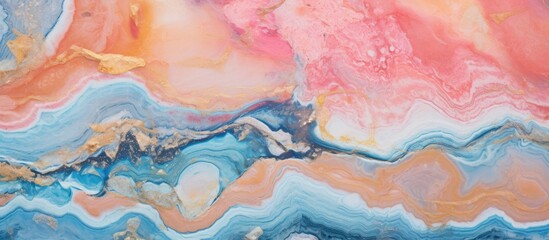 A vibrant abstract painting featuring a mix of blue, pink, and orange hues in a dynamic composition. The colors blend and swirl together, creating a visually stimulating texture on the canvas.