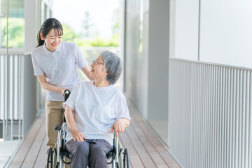 散歩する介護士・理学療法士と高齢者女性（日本人）
