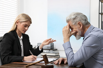 Senior man having meeting with lawyer in office