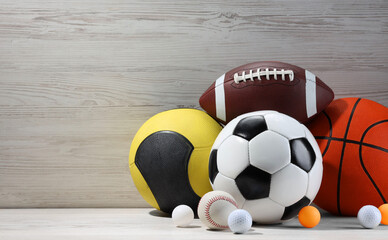 Many different sport balls on white wooden background, space for text