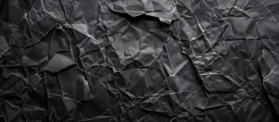 A black and white piece of paper is displayed on a dark grunge background, with visible texture and contrast.