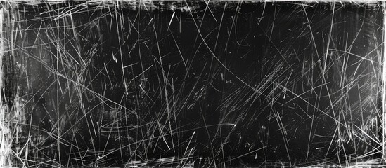This black and white image features a close-up view of grass with a scratched grunge texture. The grass blades are prominently displayed, showcasing their natural details in monochrome.