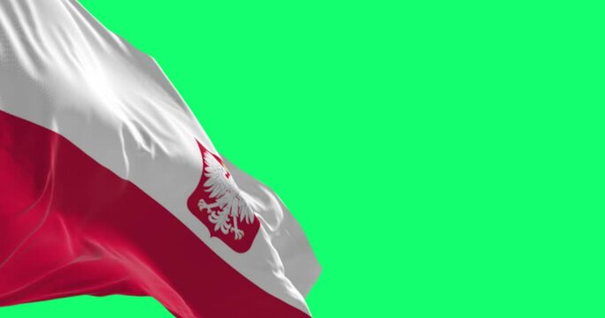 Close-up of Poland national flag waving isolated on green background