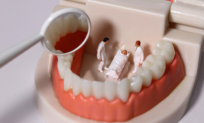 Fototapeta na wymiar Miniature doctors and patients reflecting tooth decay in a mirror. Concepts of health care and business. 
