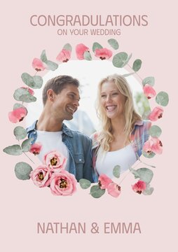 Celebrating love, a couple framed by a floral wreath radiates joy and companionship