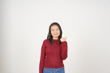 Young Asian woman in Red t-shirt Pointing side at copy space with thumb isolated on white background