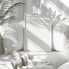 High angle and closeup view of a white wooden frame mockup lie flat on a white couch sitting area, with sunlit...