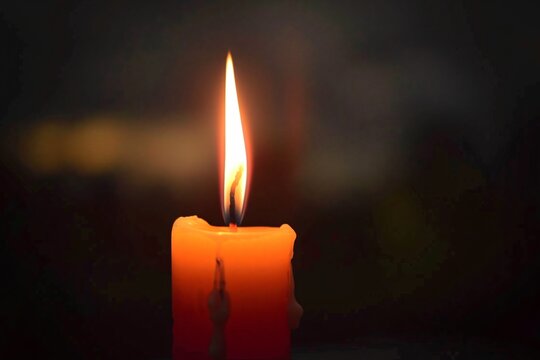 A single candle burning out the flickering flame like the last hope of a broken heart