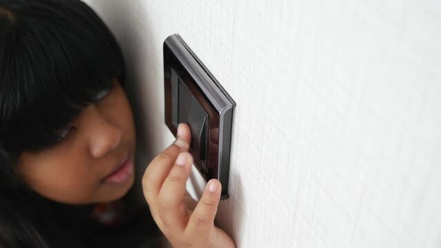  child finger turning on lighting switch with copyspace 