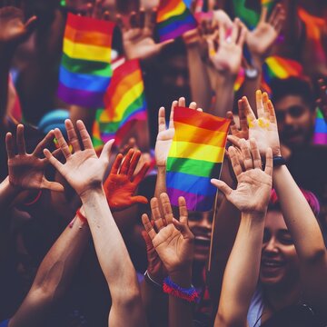 "Elevated Hands Signifying a Diverse Gathering in Colors of the LGBT Pride Rainbow Flag: Embracing Diversity, Equity, Inclusion, and Belonging"