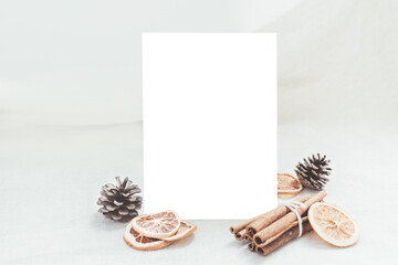 Fototapeta na wymiar blank white paper card mockup 5x7inch chirstmas holiday Ornament decoration envelope fabric winter season