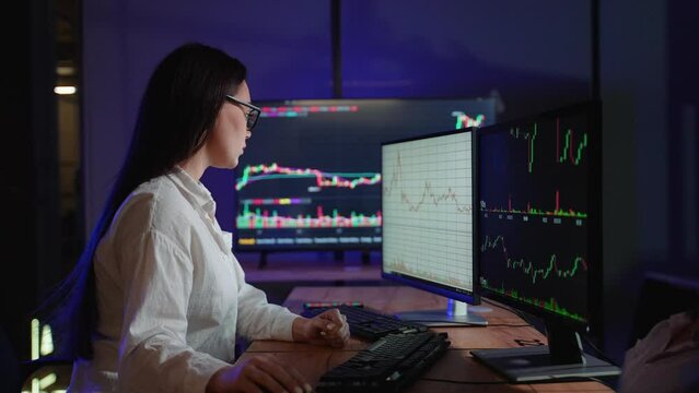 Cryptocurrency stock market woman trader investor analyst looking at computer monitor