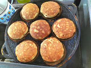 Close up shot of making Kamir. Kamir basically is a bread that almost similar to pancake from Pemalang, Central Java, Indonesia. Famous since 1970, Kamir usually served as a snack with tea or coffee.
