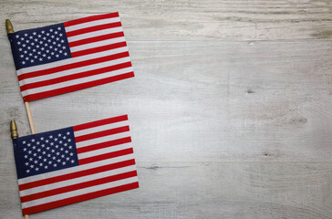 Two American Flags on a wooden background and copy space.