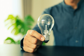 Close up hand choose light bulb or lamp for human resources or leadership and creativity thinking idea motivation or vision and knowledge learning.