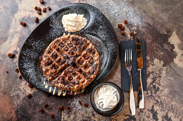 Oreos and Brownie Waffle with chocolate, whipped cream, knife and fork served in dish isolated on...