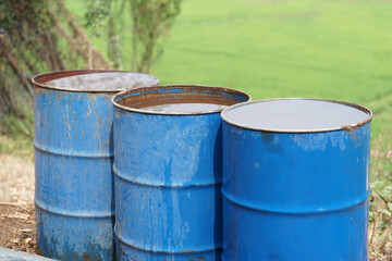Blue buckets contain water in garden. Concept, Solve problems lacking of water in agriculture by prepare water for watering plants in drought season.   
