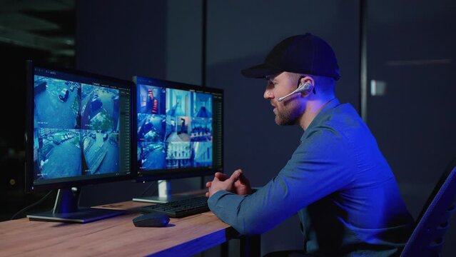 Security officer with headset in system control room answer phone call