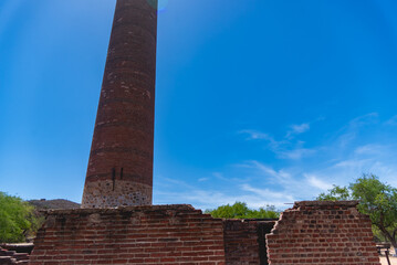 El Triunfo, Baja california, Mexico. 
A notable feature of the town is the 47-meter-high smokestack constructed in 1890 for El Progreso Mining Company . "La Ramona", named after Saint Raymond