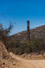 El Triunfo, Baja california, Mexico. 
A notable feature of the town is the 47-meter-high smokestack constructed in 1890 for El Progreso Mining Company . "La Ramona", named after Saint Raymond