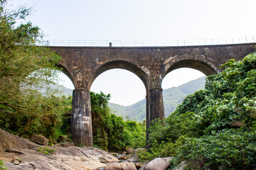 Fototapeta na wymiar Don Ca Arch Bridge At Hai Van Pass, Vietnam. This Bridge Is A Part Of An Elevated Vietnam Railway Track With Beautiful Landscape.