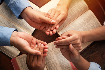Group of Christians are congregants join hands to pray and seek the blessings of God, the Holy...