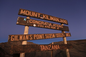 the sign of gilmans's point on the way up to mount kilimanjaro
