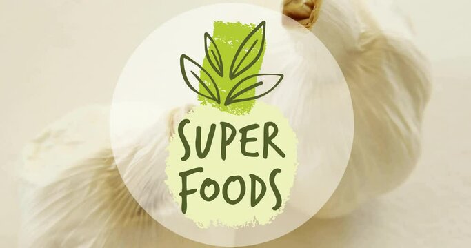 Animation of super foods text over garlic on white background
