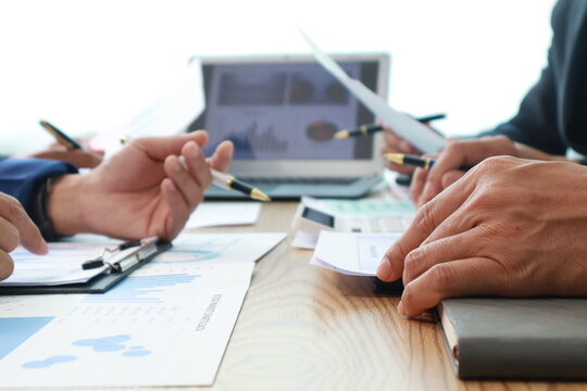 Close-Up Hand Business People Meeting Agenda at Desk, Stock Trends