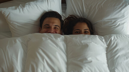 Fototapeta na wymiar A couple peeks out playfully from under a white duvet in bed, their expressions full of joy and comfort in an intimate and cozy bedroom setting.