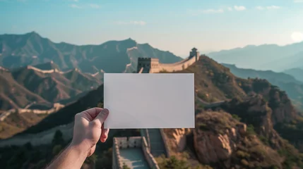 Fotobehang hand holding a blank sheet of paper, with the Great Wall of China in the background, Ai Generated Image © mohammad
