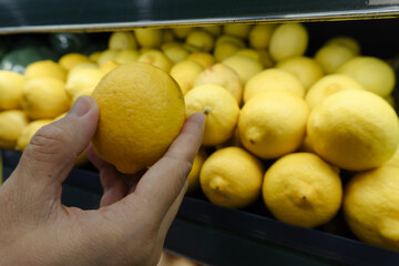 Fresh pears and bright yellow lemons, some loose and some in boxes, await shoppers at the market - 749183737