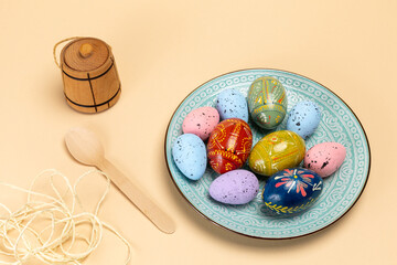 Dish with colored Easter eggs and kitchen stuffs.