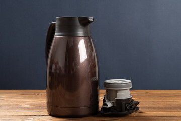 a stainless steel thermos bottle with the lid opened at horizontal composition