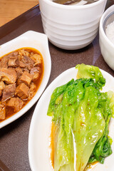 angle view five-spice beef brisket rice and coconut chicken soup with mushrooms at vertical composition