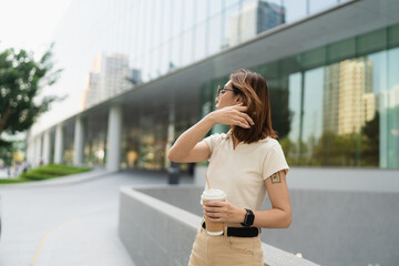Business asian entrepreneur smart woman drink coffee on office building background - 749188770