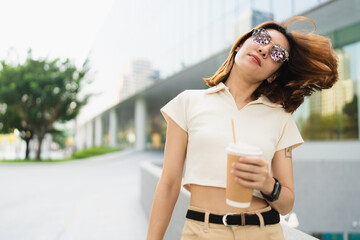 Business asian entrepreneur smart woman drink coffee on office building background - 749189174